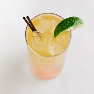 Paloma drink, garnished with a lime wedge, top view.