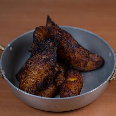 Fried sweet plantains served in a small skillet with handles.