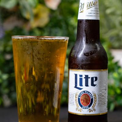 Glass of beer served alongisde a bottle.
