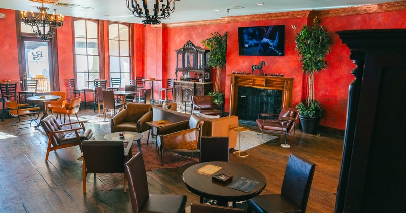 Interior, red walls, seating area with leather chairs
