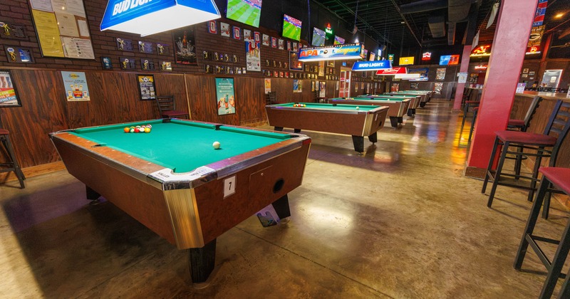 Interior, high tables and chairs near bar