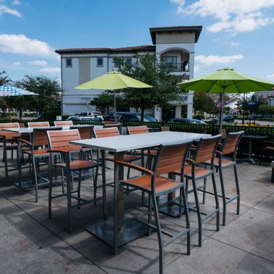 Outside sitting area with high tables and chairs.