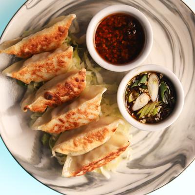 Chicken potstickers served with soy ginger glaze and chili oil.
