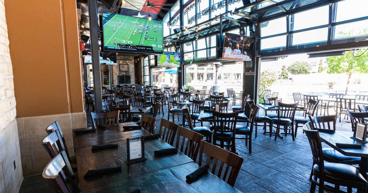 Outside, covered seating area, with TVs, tables and chairs