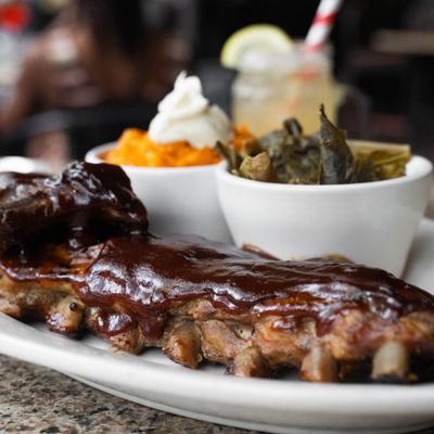 Full rack of ribs served with collard greens and Sweet Potato Mashed with Honey Butter.