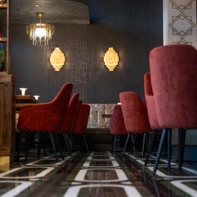 Restaurant's interior with chairs, tables and wall lights.