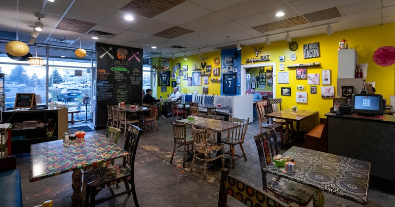 Interior, dining area with few customers in the back