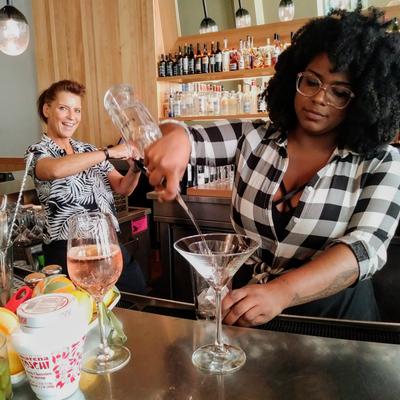 Bartenders creating cocktails for customers