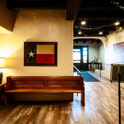 Warmly lit entryway with wood flooring and bench seating.