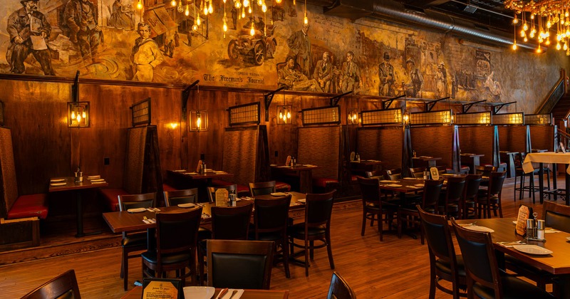 Interior, dining area, tables for eight and four people, large seating booths in the back