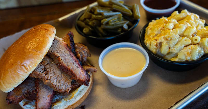 Brisket sandwich, green beans, mac and cheese, and sauce