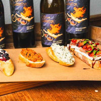 Crostini board and bottles of house wine.