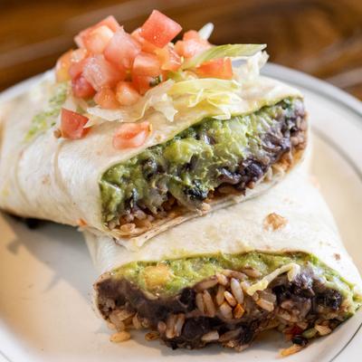 California Burrito cut in half, topped with pico de gallo.