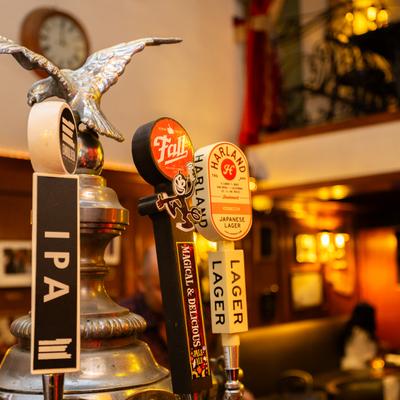 Beer tap handles featuring IPA, Fall Brewing, and Harland Lager.