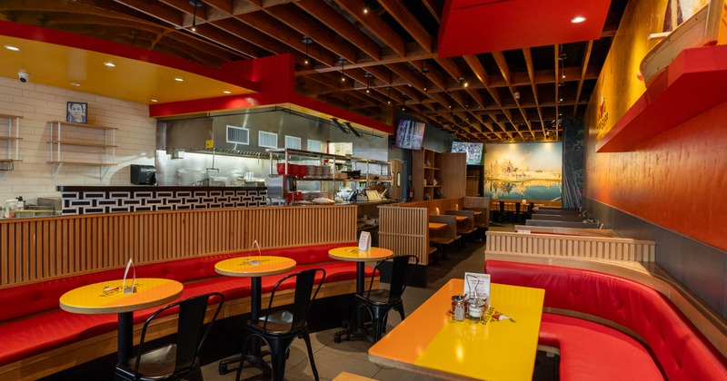 Interior, large dining area, banquette benches with tables and chairs, tile flooring