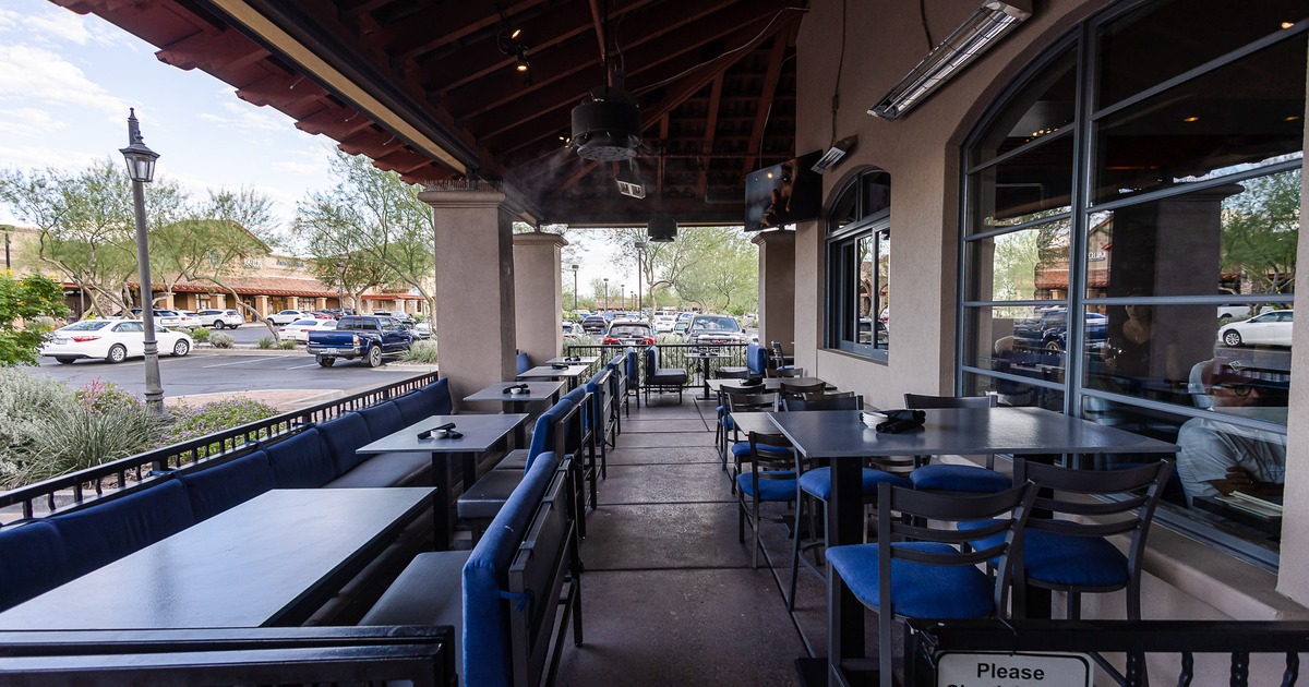 Spacious and cozy patio dining area with set tables