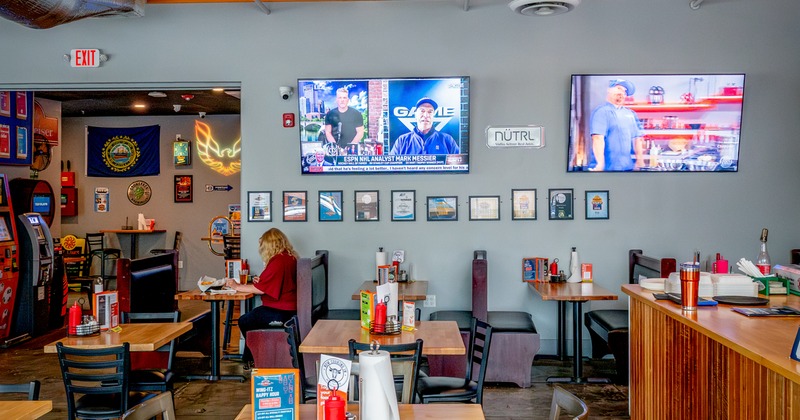 Interior, diner area, tables, chairs, tv screens