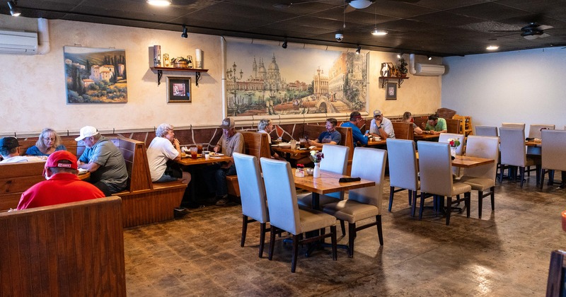 Cozy and spacious interior dining area with guests enjoying their food