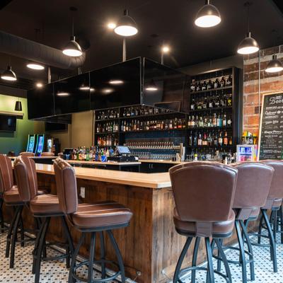 Bar area, brown leather barstools.