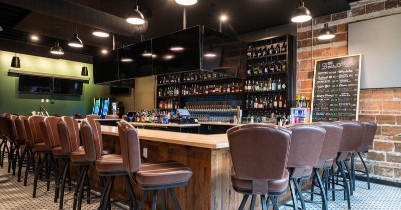 Interior, bar and bar stools, TV screens above the bar