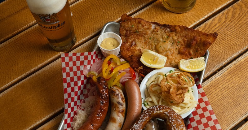 Platter with sausages, pork cutlet, pretzel, and salad