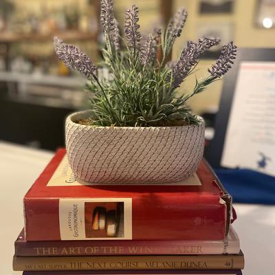 Lavender plant in pot on a stack of gastronomy books.