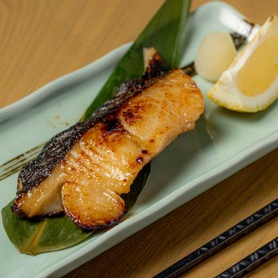 Miso Black Cod served with a side of lemon and pickled ginger.