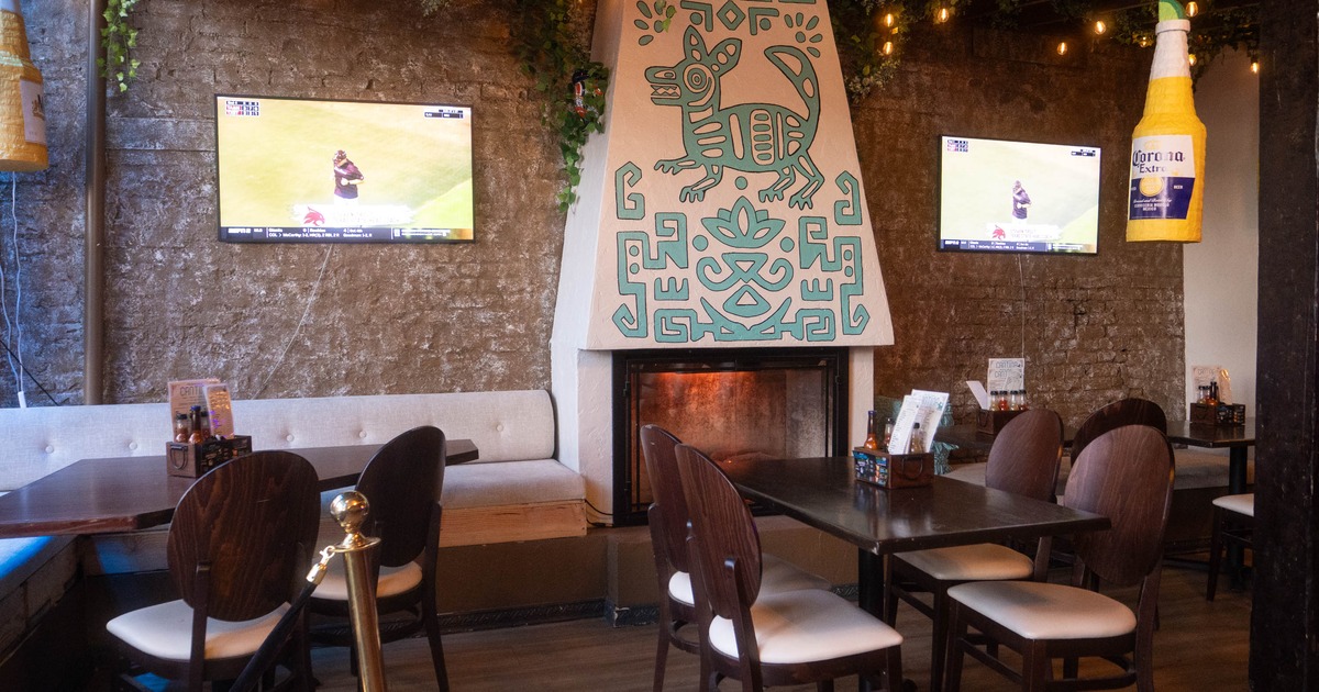 Cantina interior, seating area, table for four, corner banquette seating, built in fireplace
