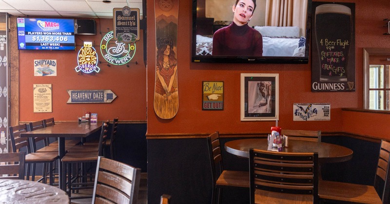 Interior, tables and chairs, a TV and wall decorations