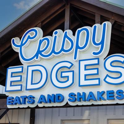 Restaurant sign on a building exterior.