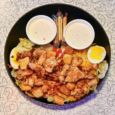 Grilled Chicken Salad with fresh vegetables, croutons, crackers and dressing.
