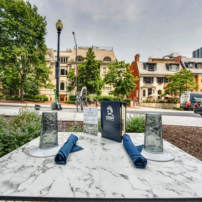 A table outside set for guests.