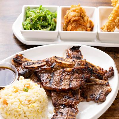 Marinated charbroiled short ribs served with sides.