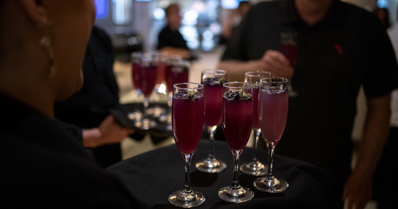 Staff member holding a tray with drinks