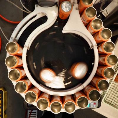 Canning line with cans being filled with beer.