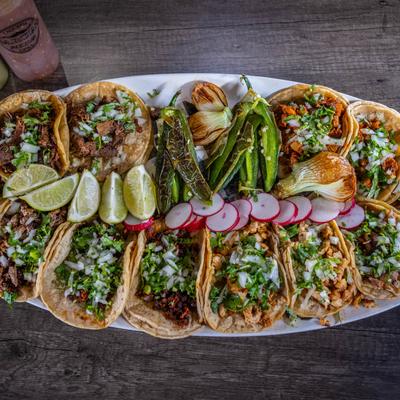 Taco platter with various tacos, top view.