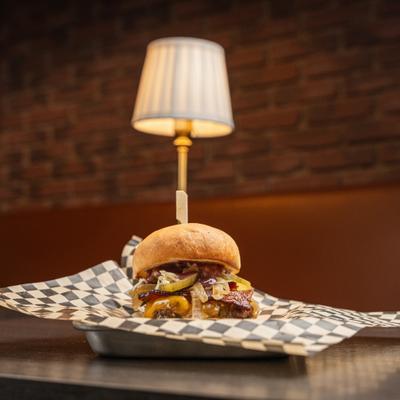 Bacon cheeseburger with caramelized onions, balsamic, hot honey pickles, and slaw.