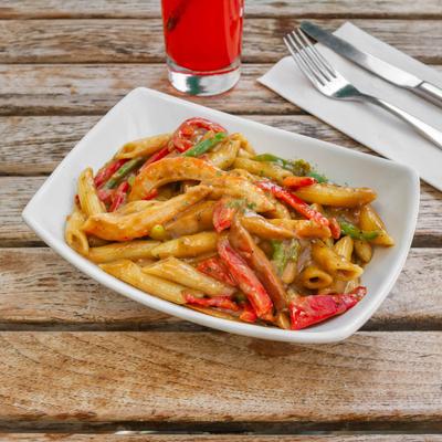 Vegan shrimp pasta, with peppers, garlic, jerk seasoning, and creamy sauce.