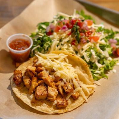 Kids chicken and cheese taco with side salad and salsa.