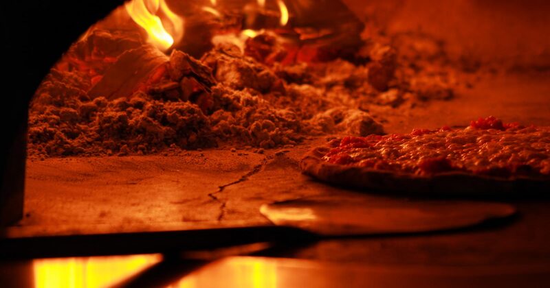 Pizza baking in a furnace, closeup