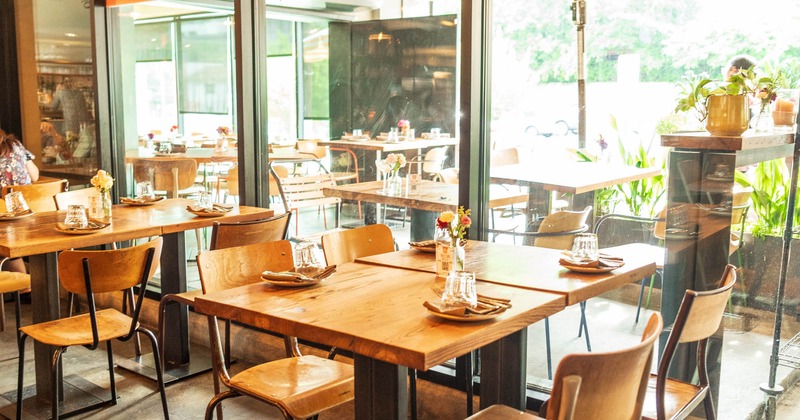 Inside, dining tables near the windows