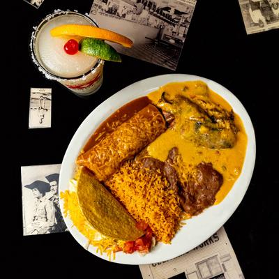 Smothered burrito, taco, and stuffed pepper, served with rice and refried beans.