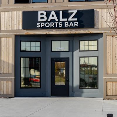 View at the restaurant's entrance with a sign above it.