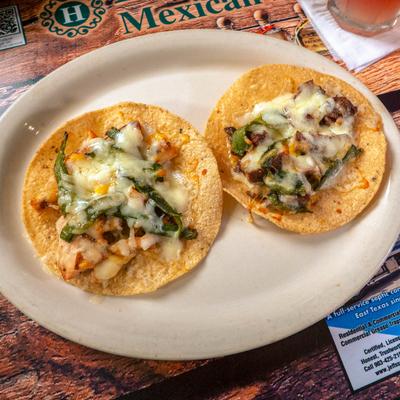 Tostada Poblamas with green peppers and melted cheese, overhead view.