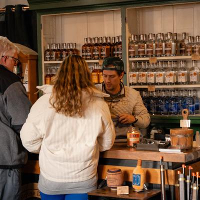 An employee serving customers in the store.