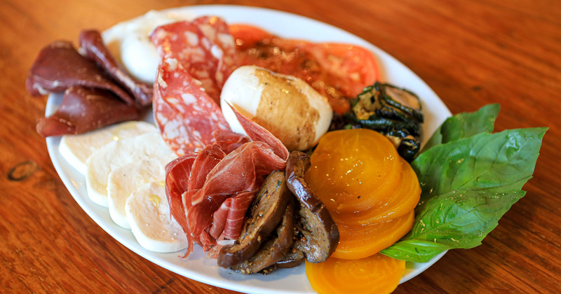 Various meats, cheese and vegetables served on platter
