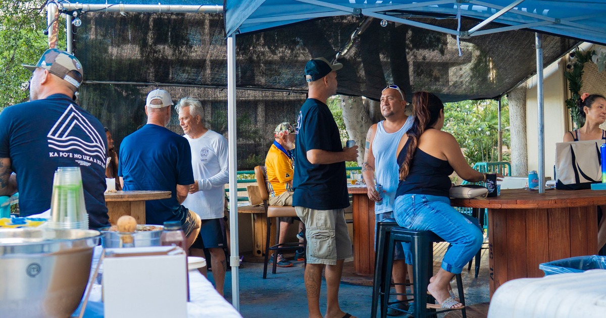 Exterior, patio, parasols, guests, bar behind