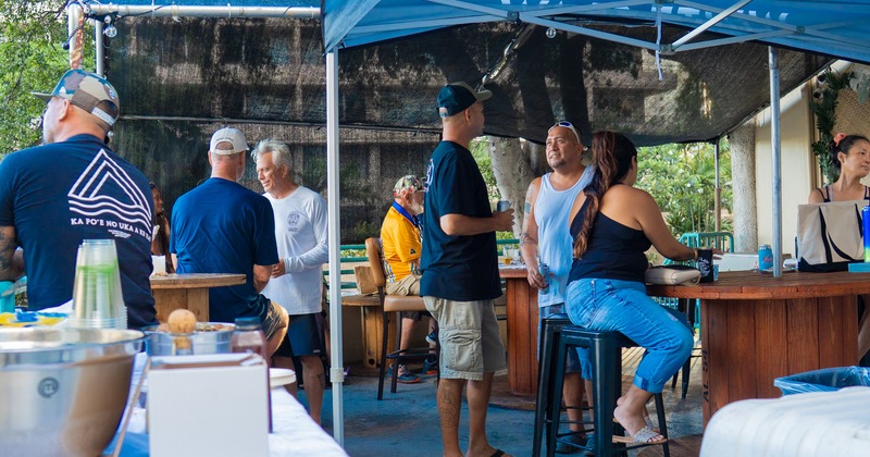 Exterior, patio, parasols, guests, bar behind