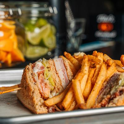 Club sandwich with fries.