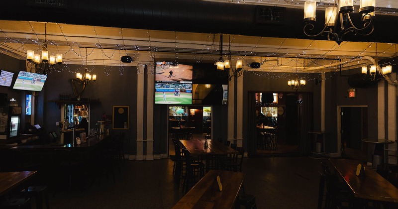 Interior, tables and chairs, TV screens on the wall